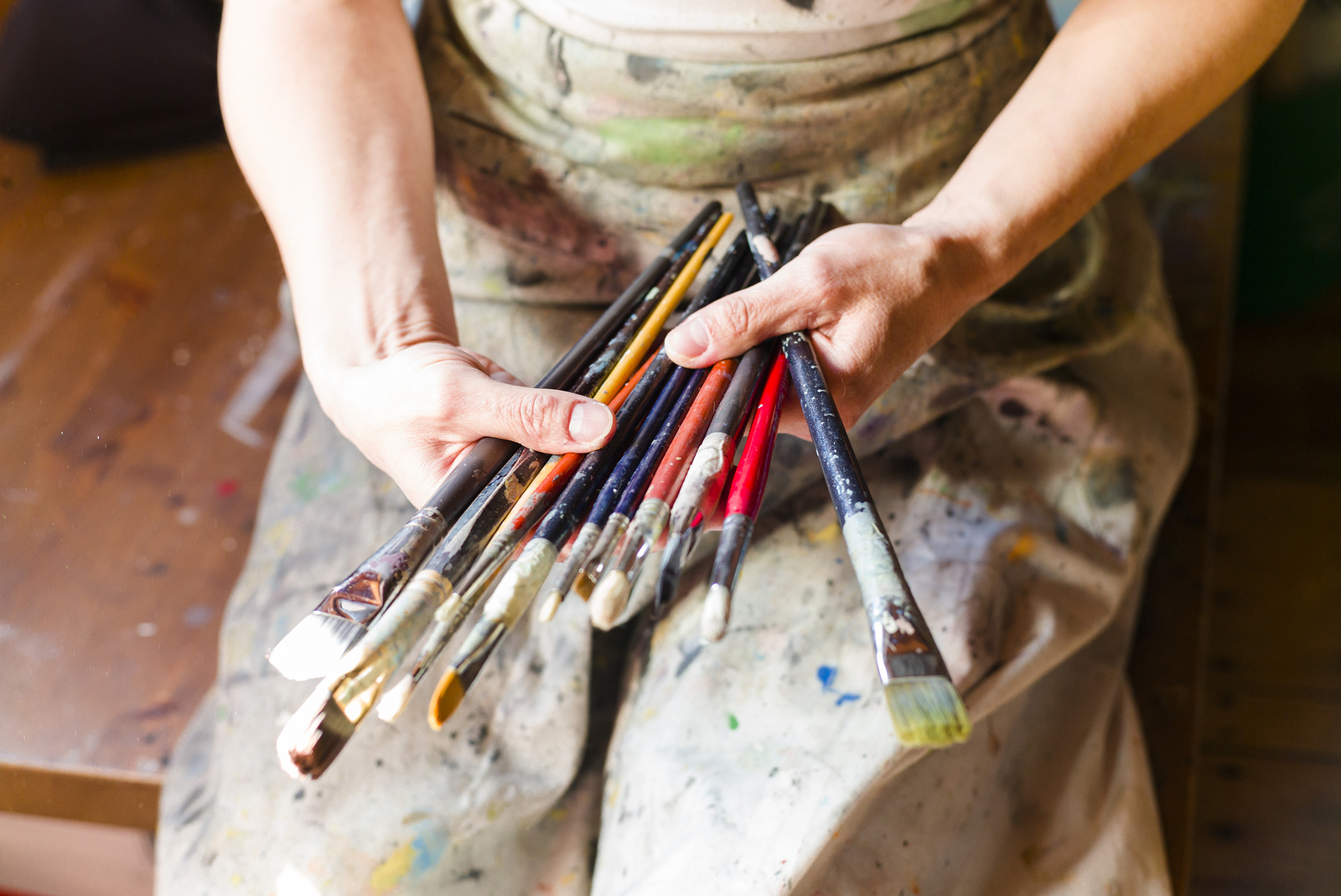 Close Up Of Woman Artist Painting Oils In His Studio, Holding Pe